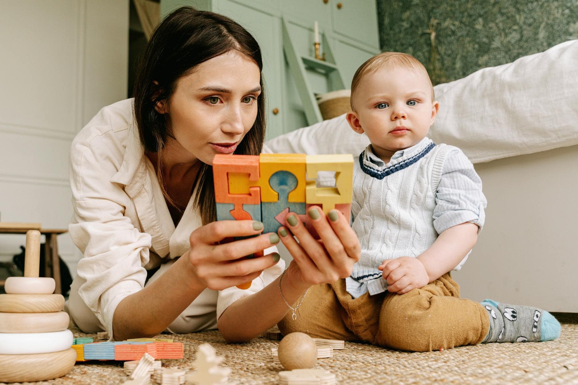 woman in white long sleeve shirt playing with baby on Mother's day